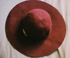 Deep burgundy wide-brim felt hat with subtle metallic detail, 100% wool