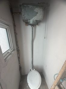 High toilet cistern and patio doors