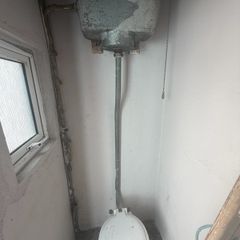 High toilet cistern and patio doors