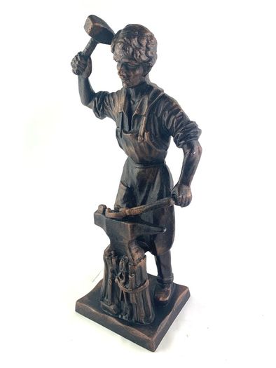 Vintage metal figurine of a blacksmith