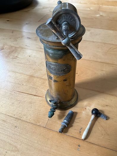 This is an antique  Dr. Eguisier brass irrigator, a medical instrument patented in 1843.