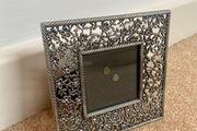 Small metal picture frame with flower detail