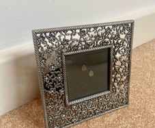 Small metal picture frame with flower detail