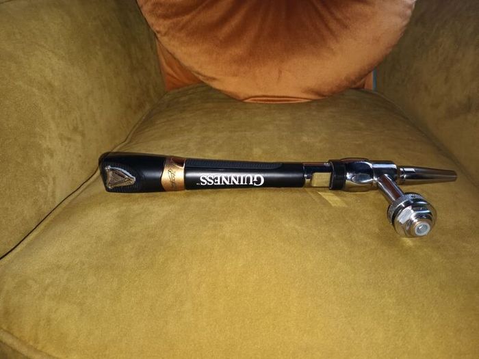 Guinness tap with stainless steel creamer nozzle.