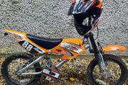 Orange pedal bike with helmet