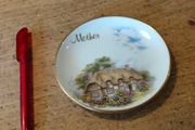 English china  plate featuring a thatched cottage scene