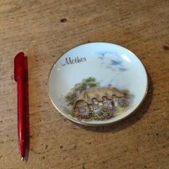 English china  plate featuring a thatched cottage scene