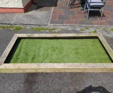 wooden graveside surrounding with astro