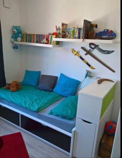 Ikea Flaxa bed with storage headboard.