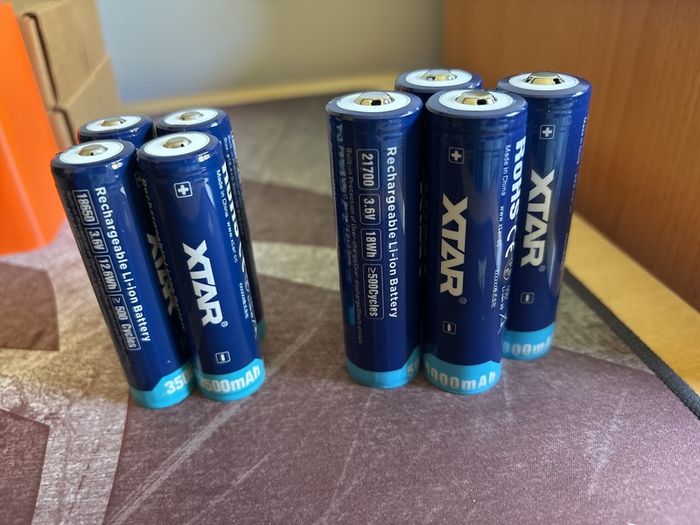Four 18650 and 21700 Xtar button top batteries