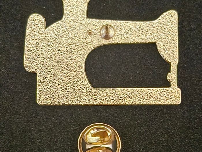 Sewing machine, pin back badge.