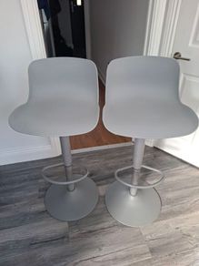 Two adjustable grey breakfast bar stools