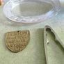 3 different items. No. 1- Vintage Brass Motto Plaque / Shield. In Great Condition. 38.00 euro. 2- KitchenCraft Chrome Nut Cracke 12.00 euro. 3- Vintage Marquis By Waterford Iris Crystal Oval is  Picture Frame but missing the back could uesd as trinklet di Image 2