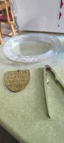 3 different items. No. 1- Vintage Brass Motto Plaque / Shield. In Great Condition. 38.00 euro. 2- KitchenCraft Chrome Nut Cracke 12.00 euro. 3- Vintage Marquis By Waterford Iris Crystal Oval is  Picture Frame but missing the back could uesd as trinklet di