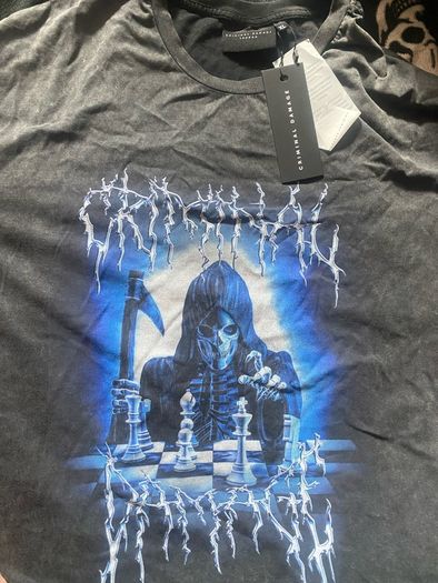 Criminal Damage Men's T-shirt Reaper Graphic Tee has a relaxed fit, short sleeves, a washed black look, and grim reaper graphics on the front.