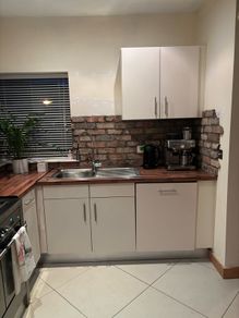Fitted kitchen. Light cream high gloss kitchen