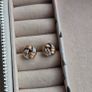 Beautiful silver and rose gold-tone knot stud earrings. Image 5