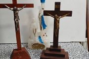 Two crucifixes and a Lourdes Our Lady holy water bottle. Religious devotional items.