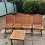 Four foldable garden chairs, one table and a parasol Image 4