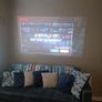 philips neopix ultra 2tv+ home projector and height adjustable stand, built in speakers and android TV with play store stand comes with power point bracket on it as seen in pictures also remote and phone holder Image 9