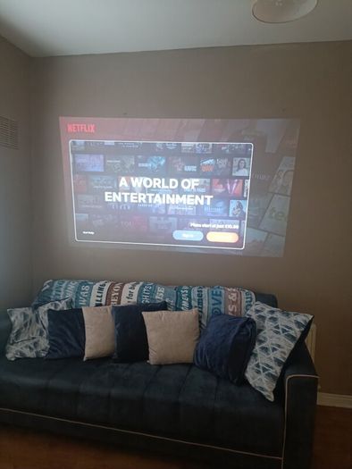philips neopix ultra 2tv+ home projector and height adjustable stand, built in speakers and android TV with play store stand comes with power point bracket on it as seen in pictures also remote and phone holder