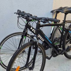 Two bikes one mountain one is a type of racing mountain bike