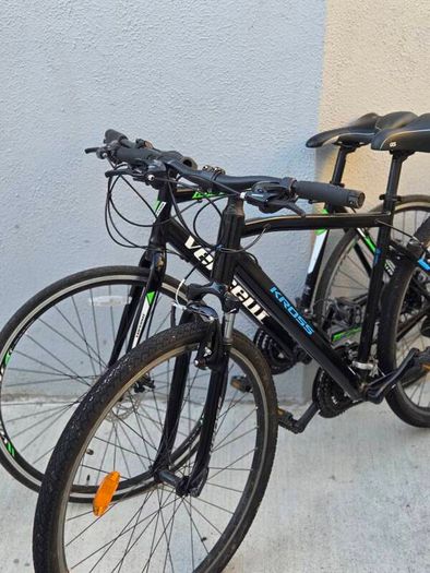 Two bikes one mountain one is a type of racing mountain bike