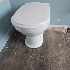 4 traditional style white ceramic toilets available for sale.