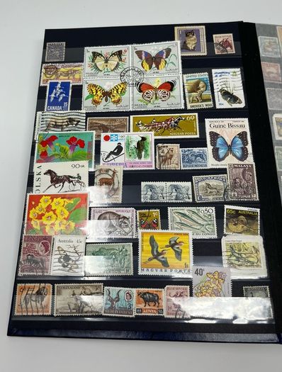 Ace Black 32 page/ 16 leaf Stamp Album with over 900 stamps. Thematic of Animals, Plants, Classic Cars, Space, Trains, Sport & Disney noted.