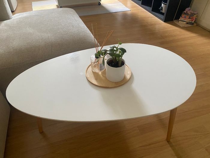 Oval white coffee table with wooden legs