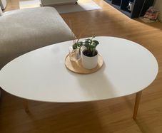 Oval white coffee table with wooden legs