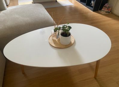 Oval white coffee table with wooden legs