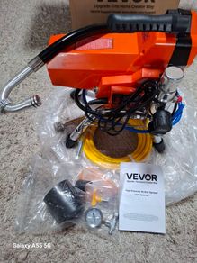 Airless paint sprayer with high pressure hose.