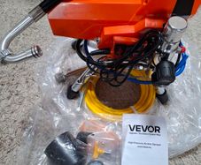 Airless paint sprayer with high pressure hose.