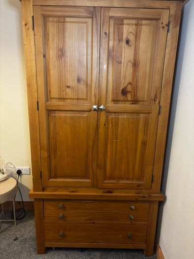 wardrobe with double hanging rails. 2 bottom drawers, 58cms deep and 106cms wide at the widest part.