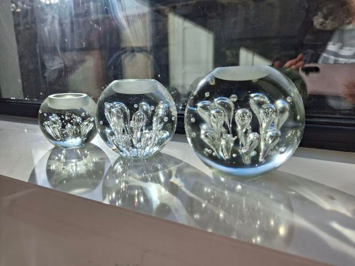 3 x cylindrical glass candle holders.