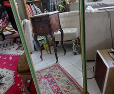 Vintage wall mirror in a green gold trimmed frame 1950s