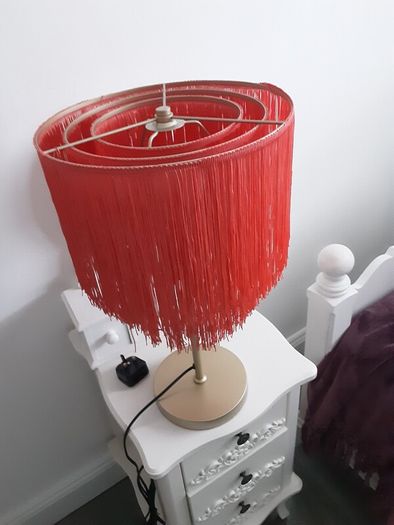 Orange fringed lamp on bass base