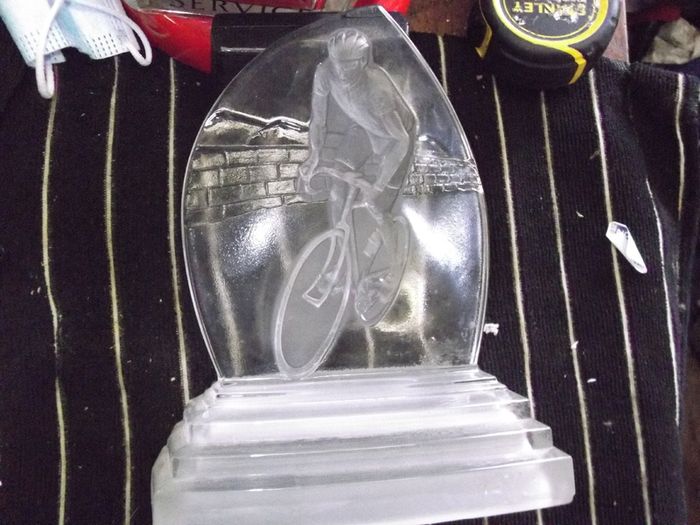 a cut glass with a cycle on it