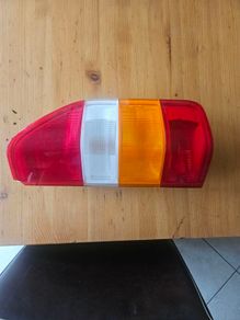 Tail Light Assembly Left Side. Slight damage on corner. See photos for same.