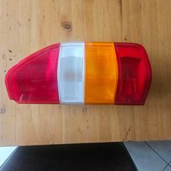 Tail Light Assembly Left Side. Slight damage on corner. See photos for same.