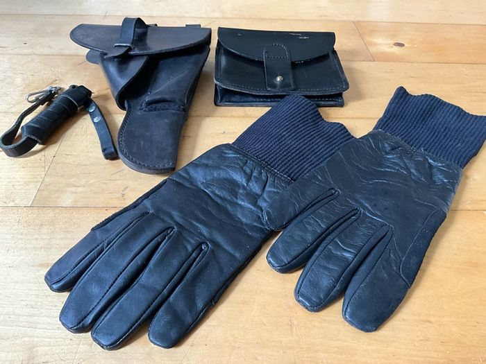 Vintage military-style black leather gear, likely representing a pistol holster, ammunition pouch