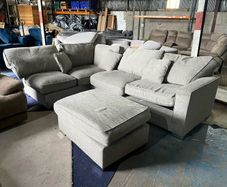 Large grey corner sofa with footstooll