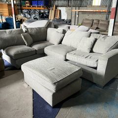 Large grey corner sofa with footstooll