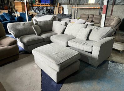 Large grey corner sofa with footstooll