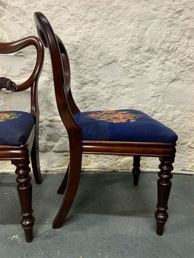 A pair of Victorian mahogany balloon back chairs with tapestry seats.