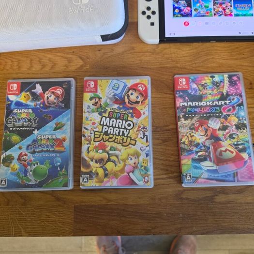 Nintendo Switch OLED (plus 3 games and travel case)