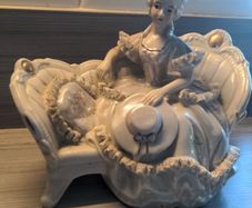 VINTAGE Porcelain Victorian Lady on Sofa Woman Statue Figurine sitting holding hat wearing a beautiful dress