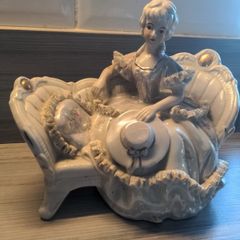 VINTAGE Porcelain Victorian Lady on Sofa Woman Statue Figurine sitting holding hat wearing a beautiful dress