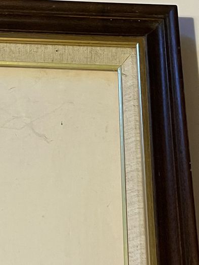 frame A rich dark-wood and gilt picture frame featuring a textured fabric mat liner.